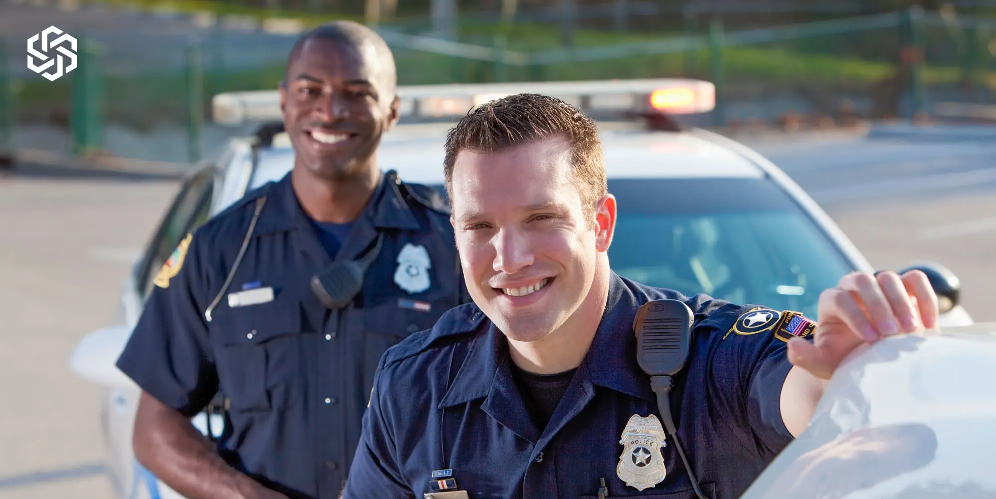 Police officers standing in front of a patrol car, representing strength, focus, and hormone health support through testosterone therapy in Lake Forest, Illinois.