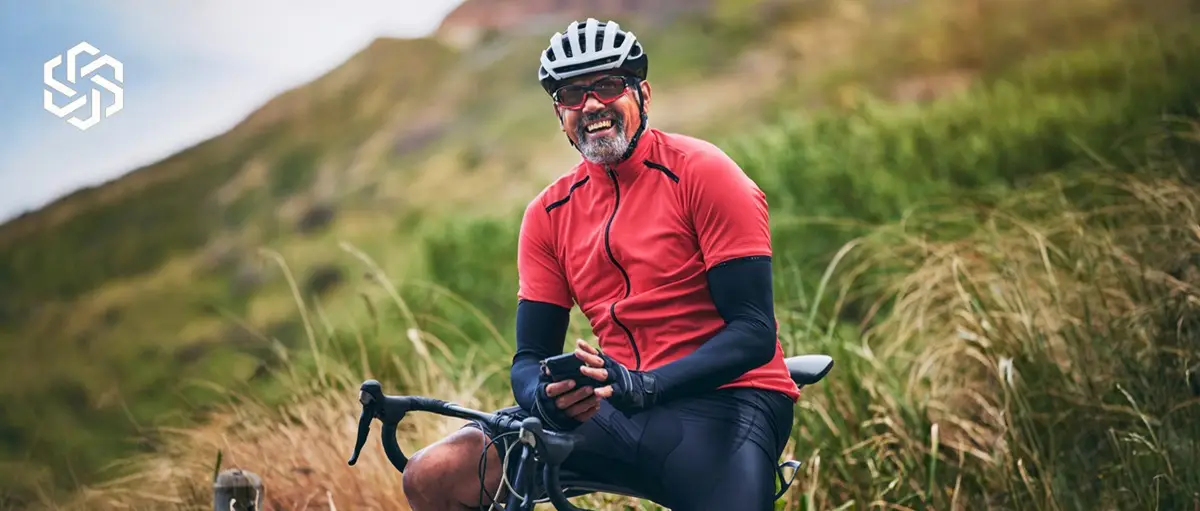 Active man smiling outdoors, representing improved pelvic floor strength and bladder control with Emsella® therapy