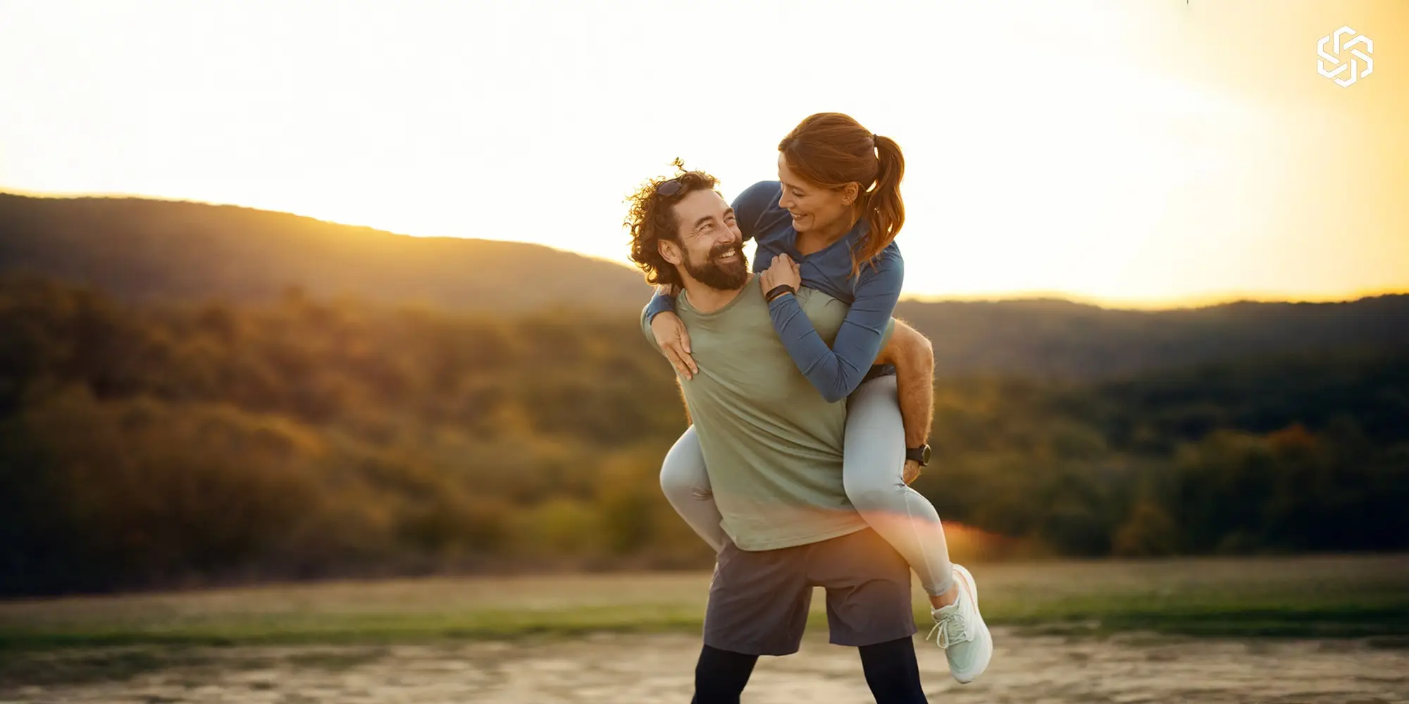 Active couple enjoying a hike outdoors, smiling and feeling energized together
