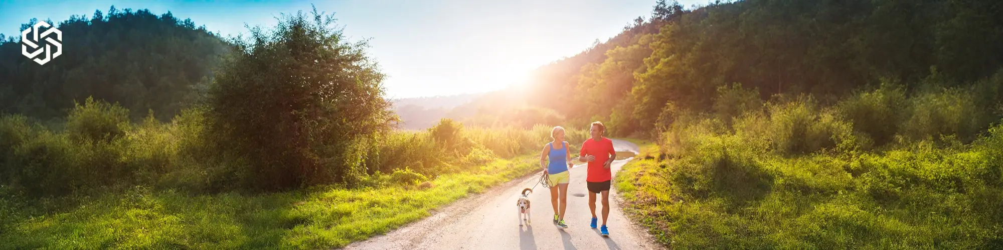 Man and woman walking outdoors with dog representing targeted peptide therapy supporting metabolic, immune, and regenerative health