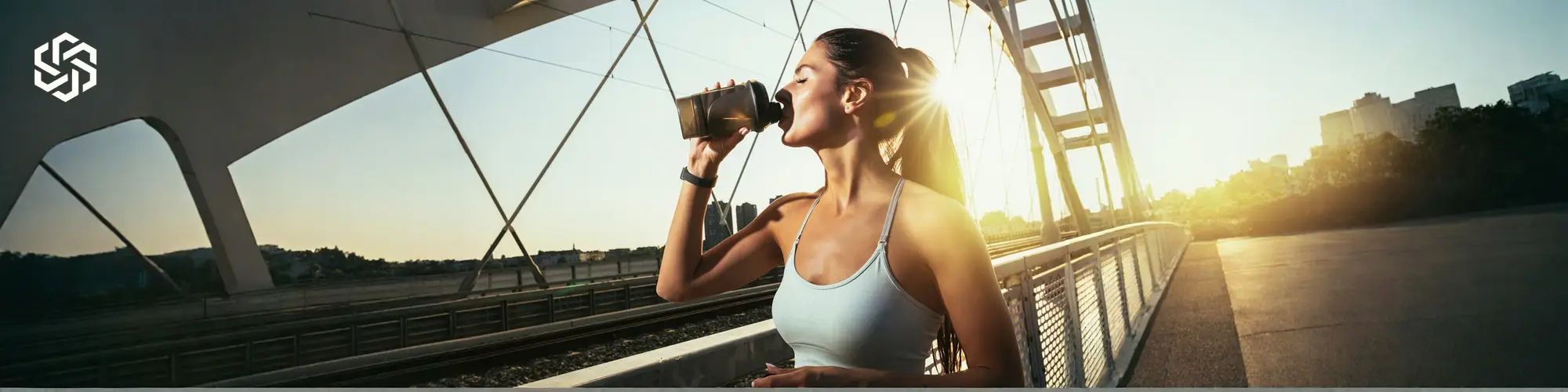 Active woman drinking water outdoors for Lipo B+C injection energy and metabolism support.