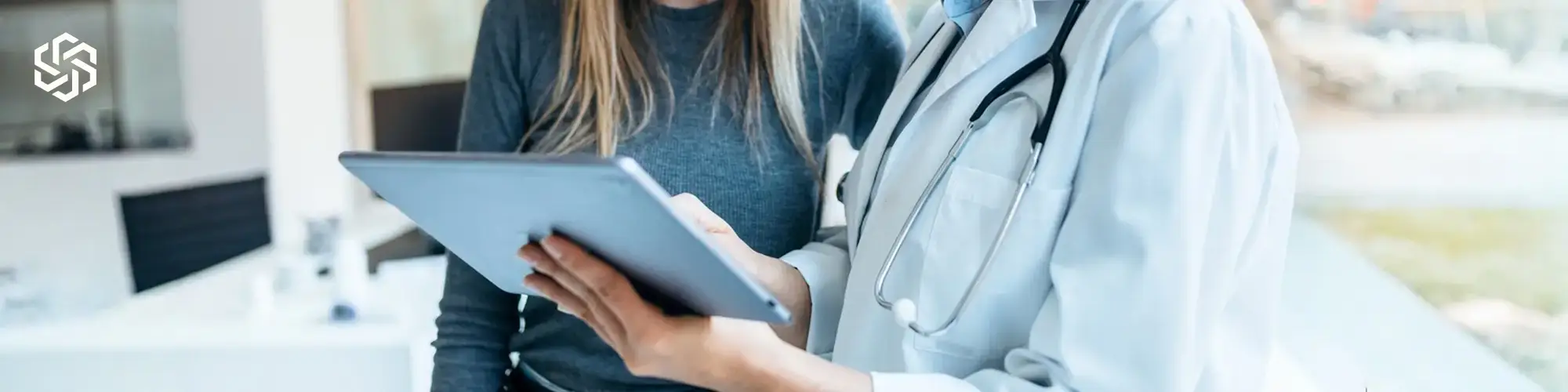 Medical provider reviewing health information with patient during personalized care consultation.