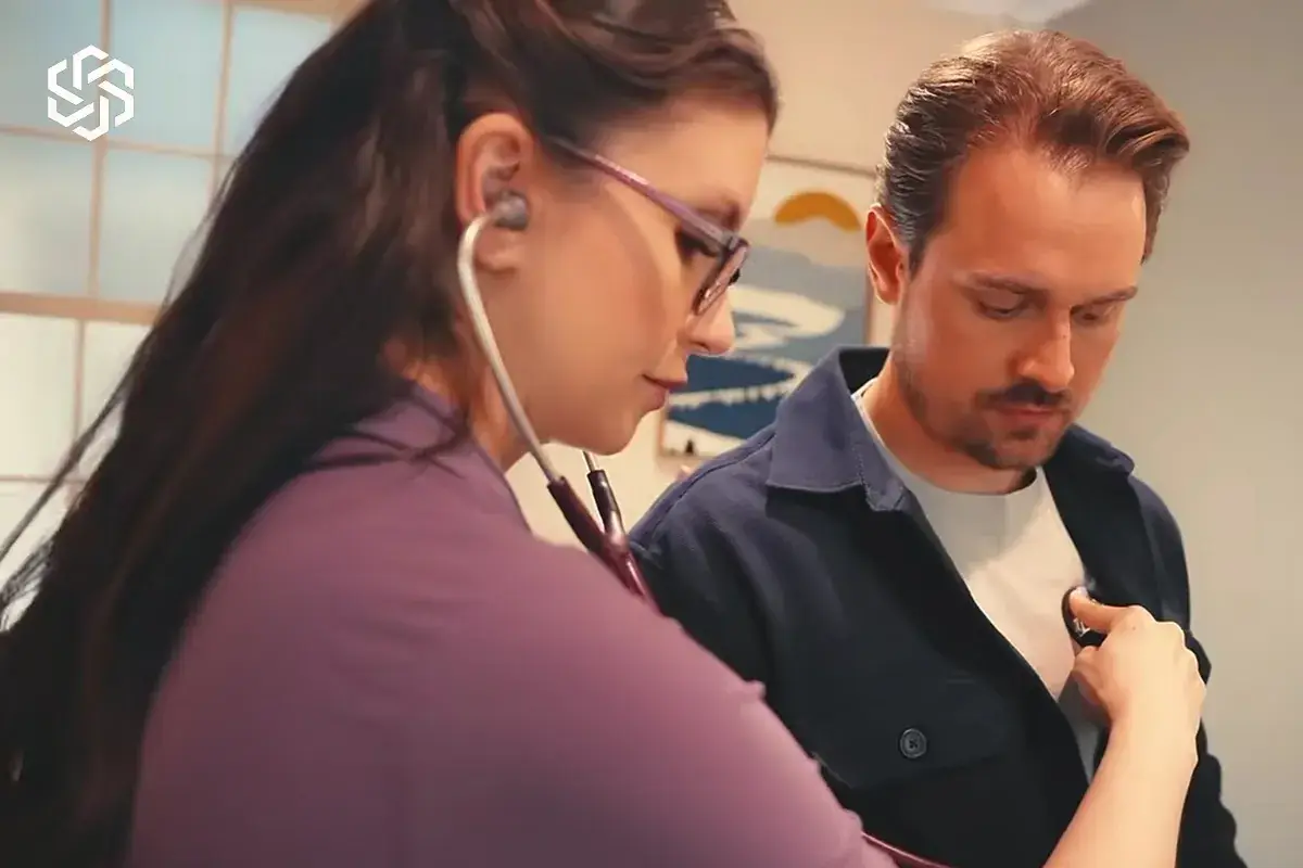 Clinician listening to a patient's heart with a stethoscope during a direct primary care visit at Lake Forest Regenesis in Lake Forest, IL