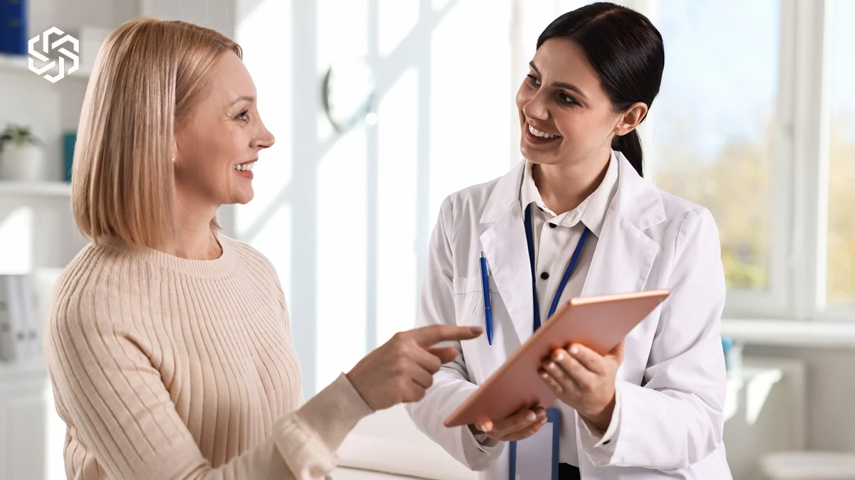 Provider reviewing a tablet with a smiling patient