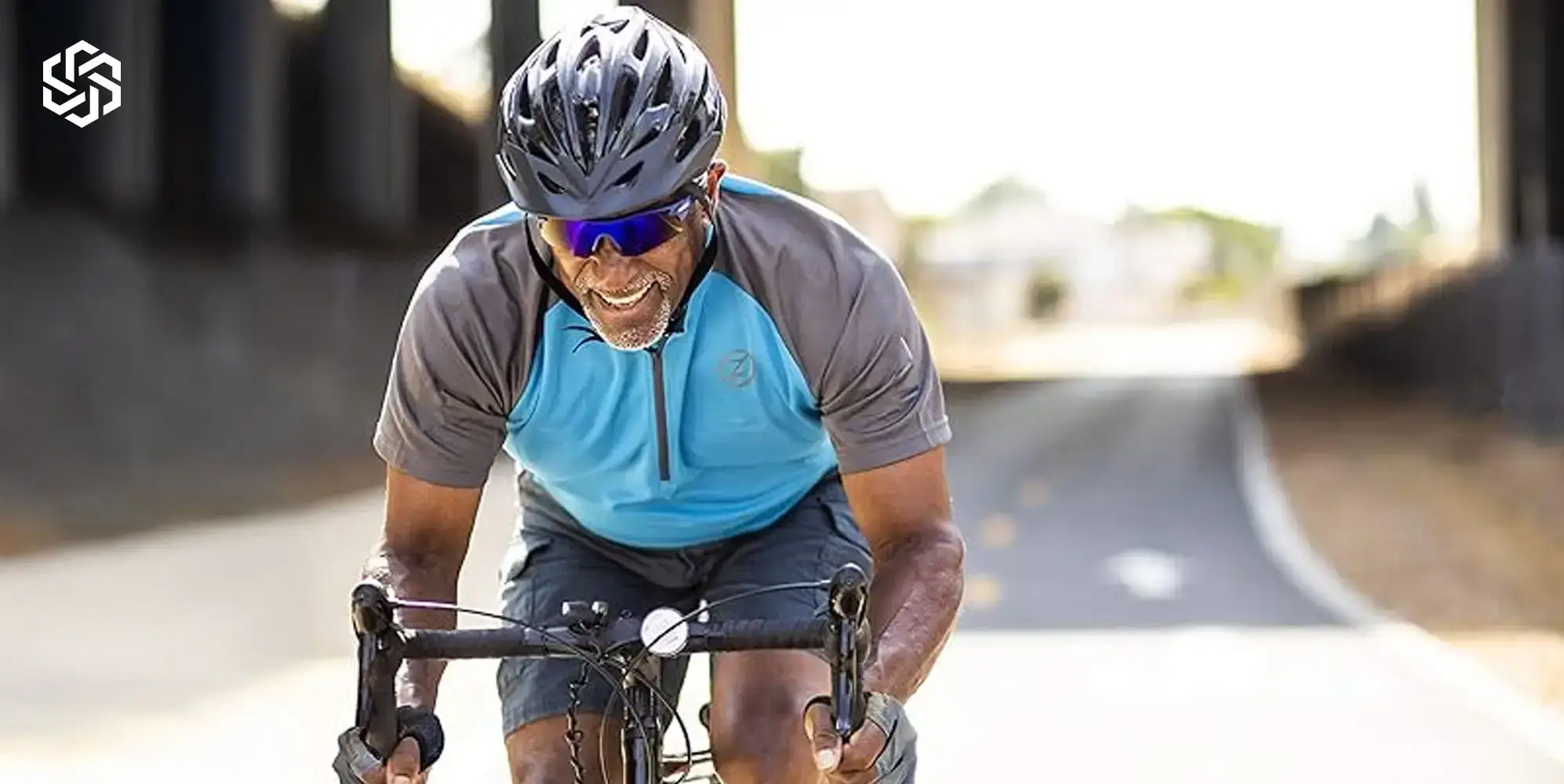 Active midlife man cycling outdoors representing peptide therapy, recovery, performance, and metabolic wellness.