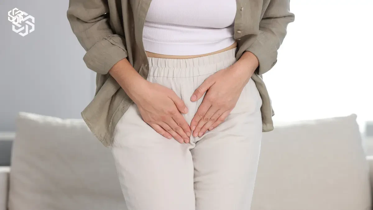 Woman pressing her hands over her lower abdomen because of urinary symptoms