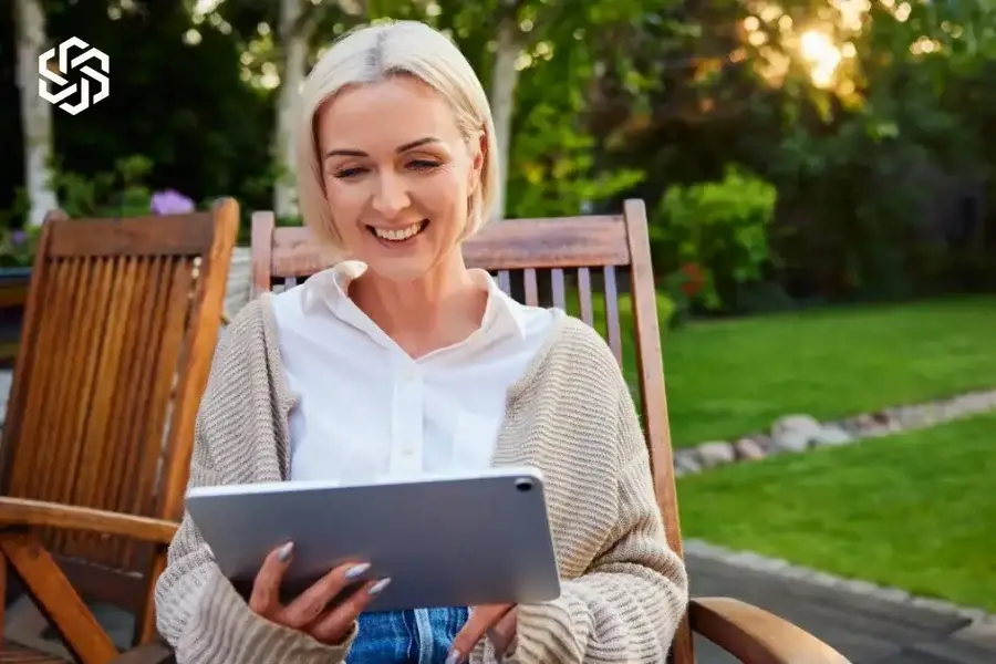 Woman relaxing outdoors with a tablet