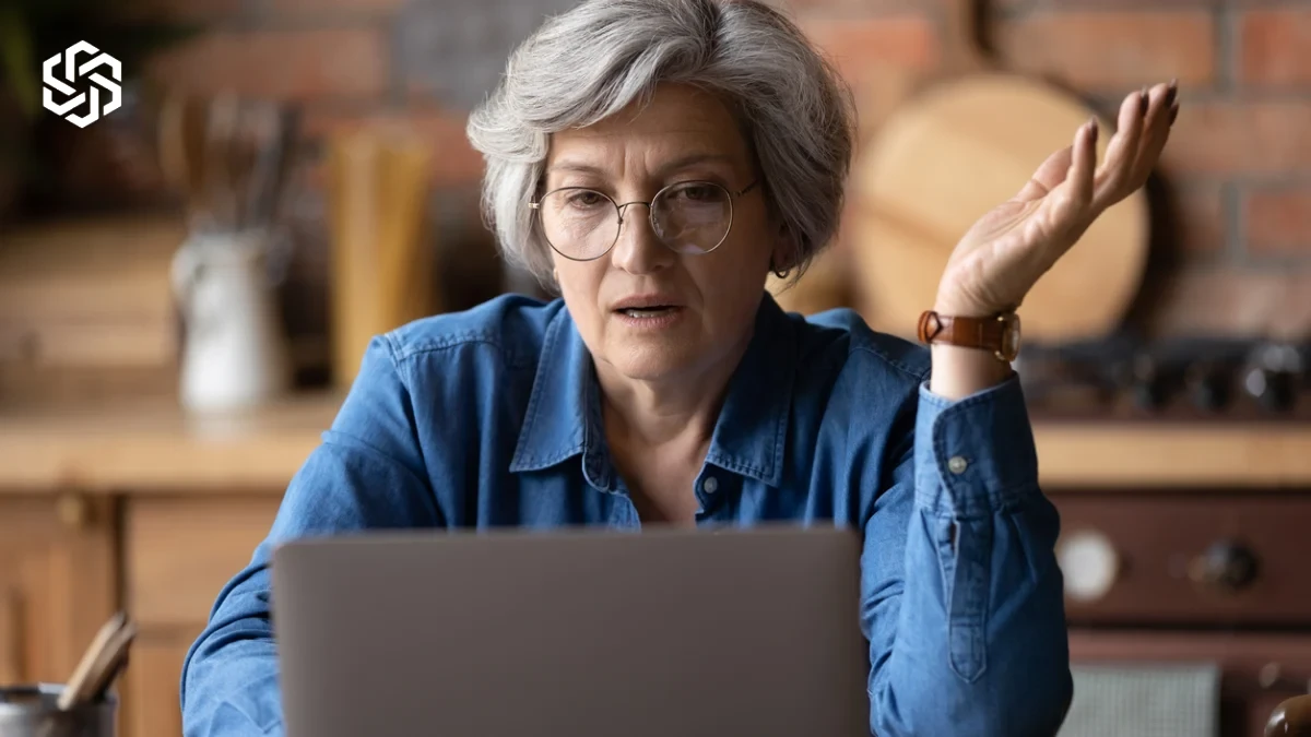 Confused woman looking at a computer screen, deciding between primary care vs. urgent care vs. ER