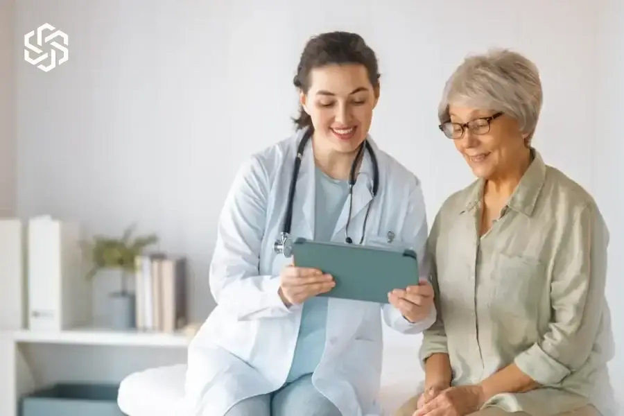 Provider reviewing a tablet with an older patient