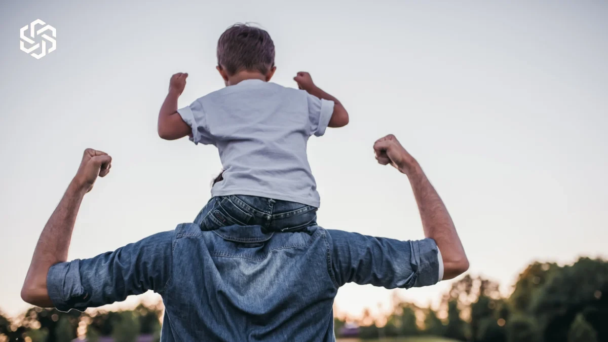 Child riding on his father's shoulders