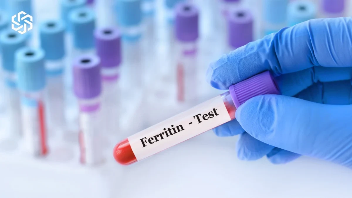 Gloved hand holding a ferritin blood test tube