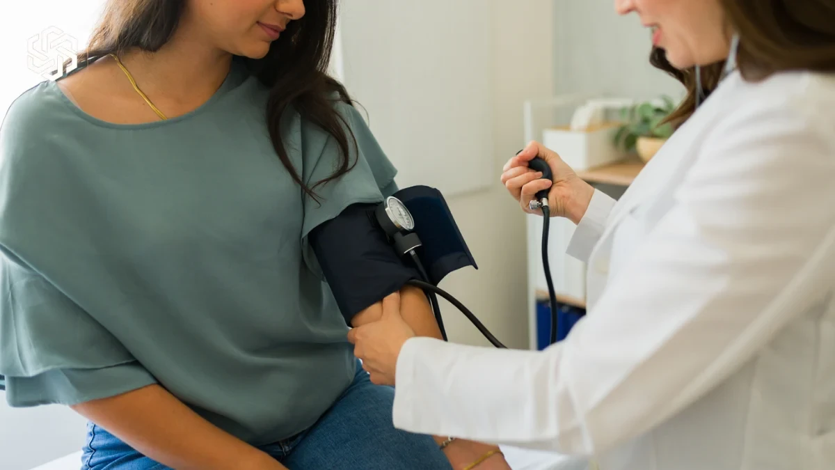 Provider checking a patient's blood pressure during a primary care visit