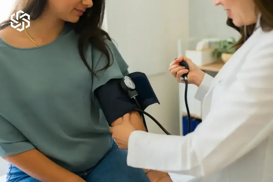 Provider checking a patient's blood pressure during a primary care visit