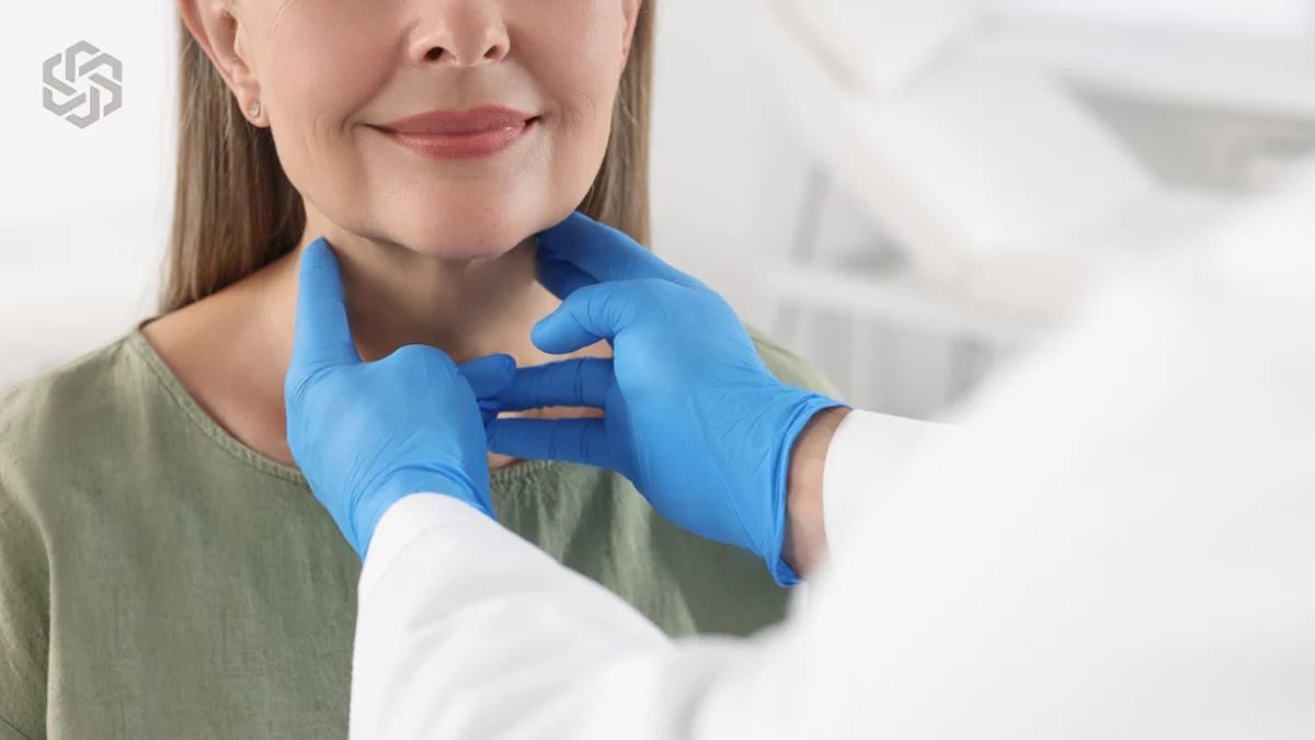 Provider examining a patient's thyroid