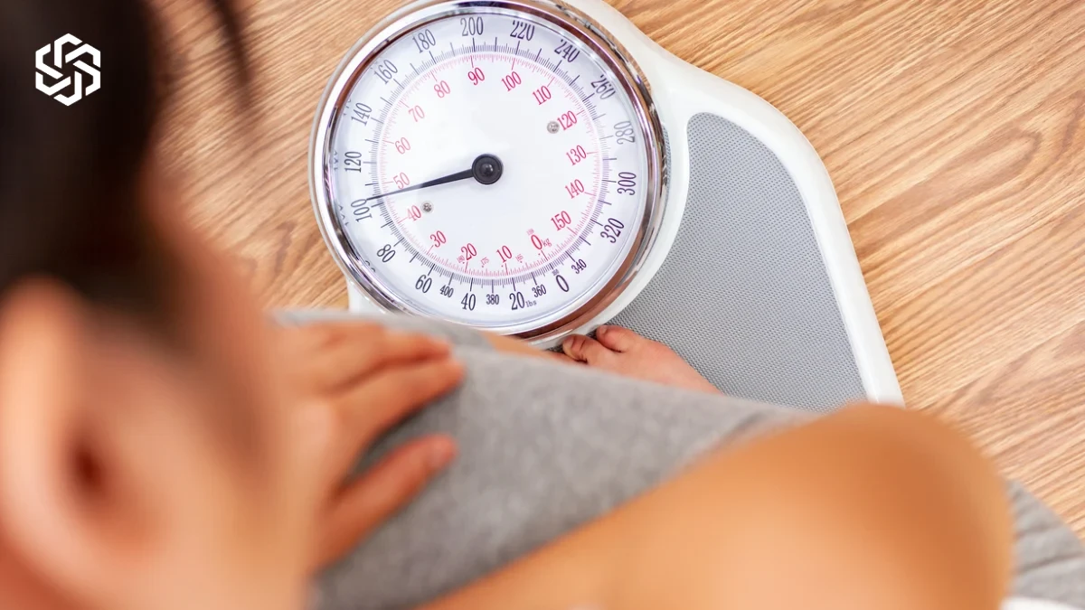 Woman checking a bathroom scale