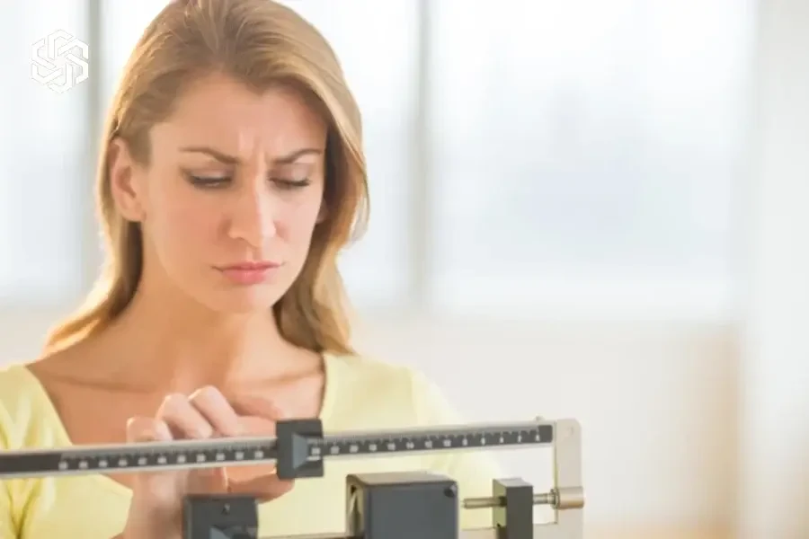 Woman adjusting a balance scale