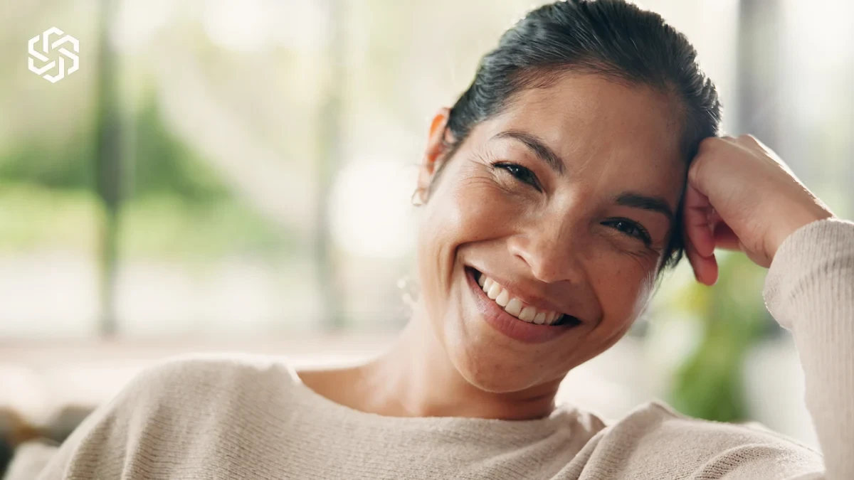 Smiling woman relaxing at home, illustrating a whole-person medical evaluation
