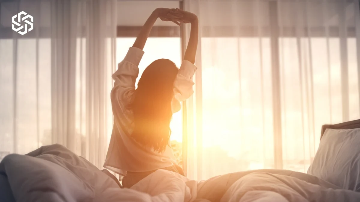 Woman stretching in bed after waking up
