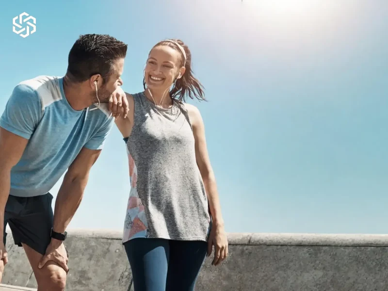 Smiling couple standing together outdoors on a sunny day