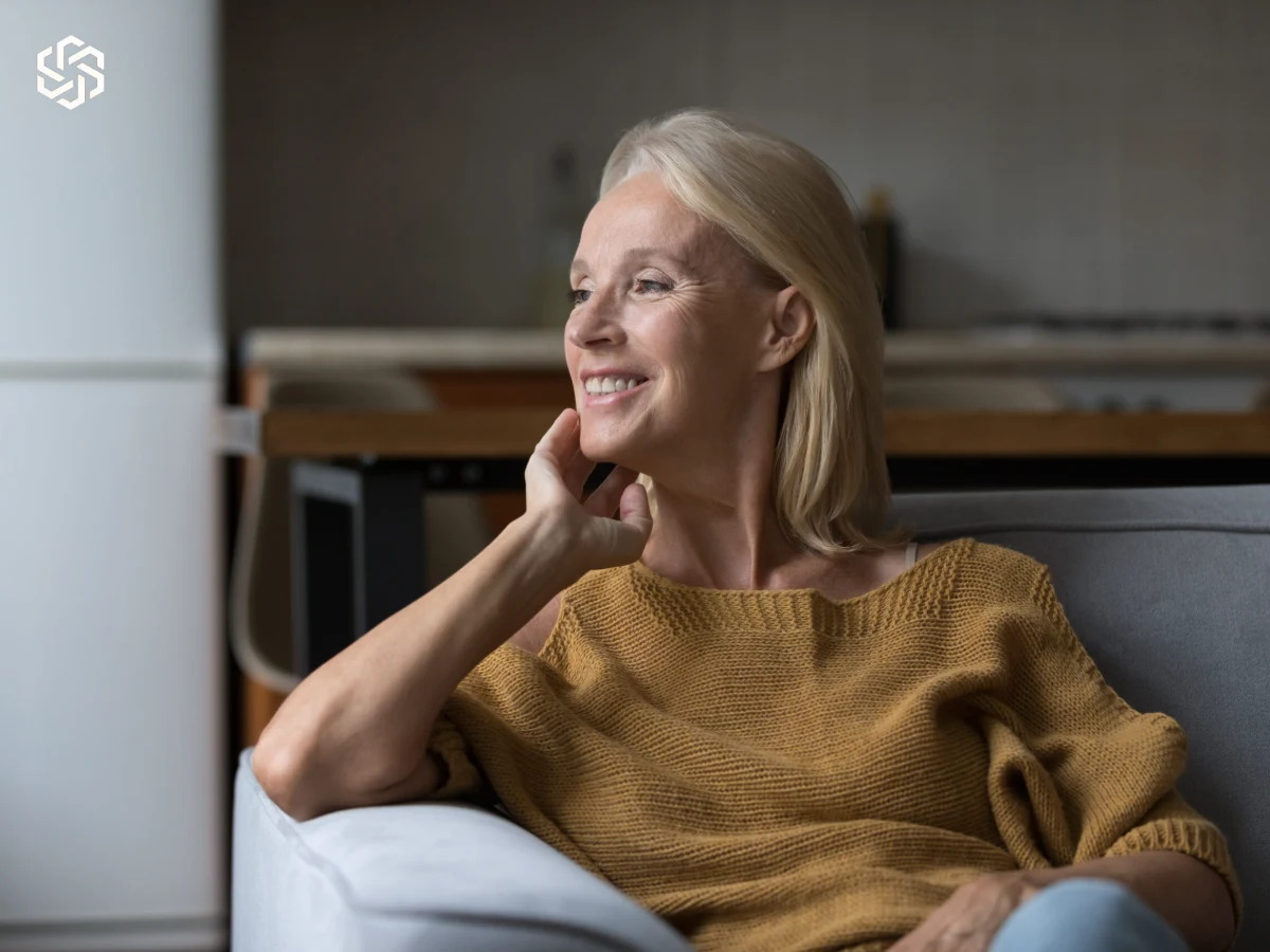 Smiling mature woman relaxing at home, illustrating the Hormones & Menopause topic