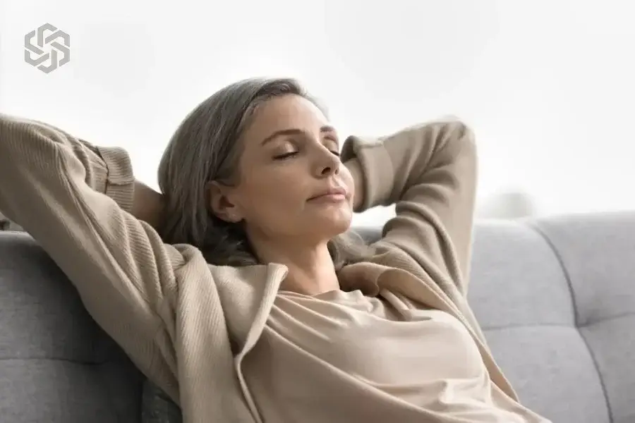 Woman relaxing on the sofa with her eyes closed