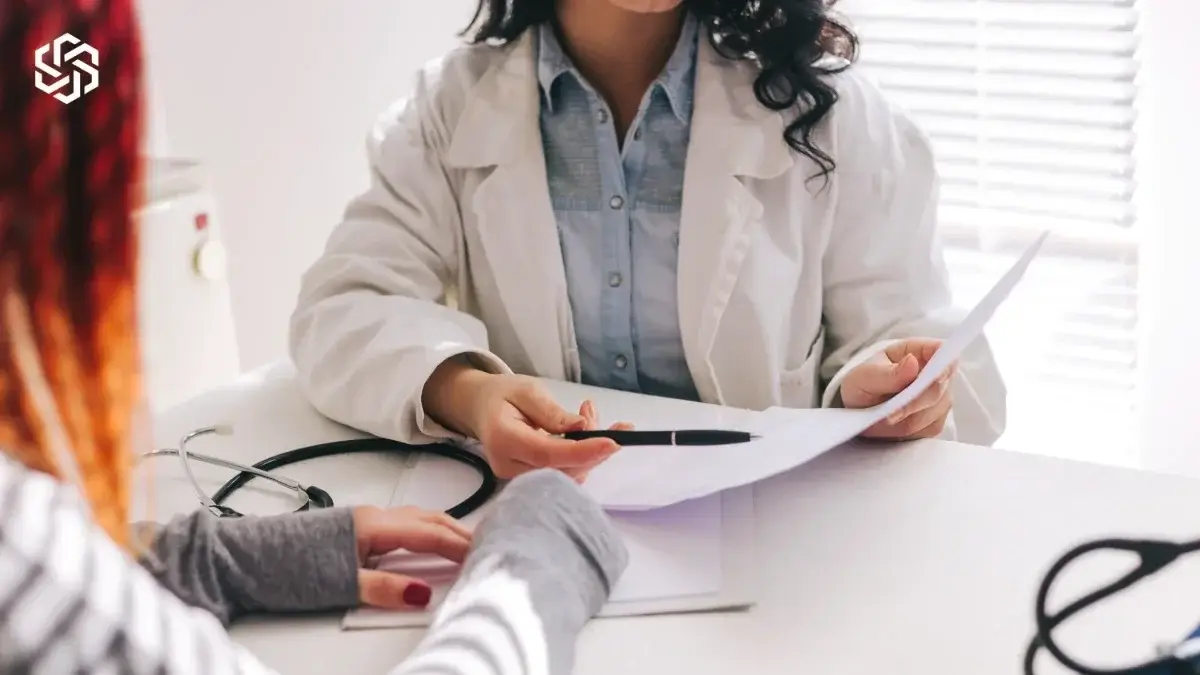 Provider reviewing lab results on paper with a patient