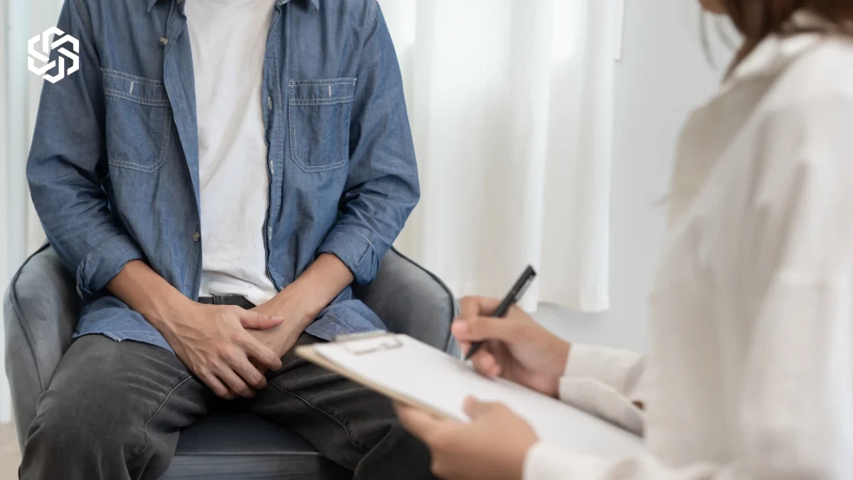 Man with pelvic discomfort at a doctor's visit