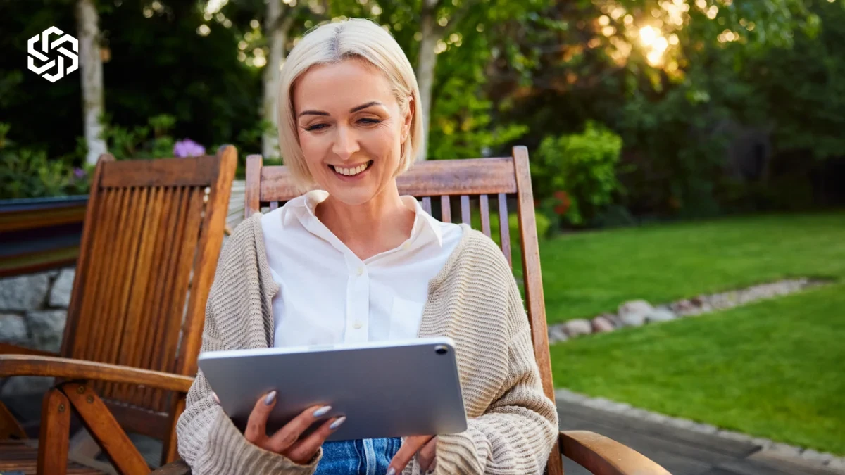 Woman relaxing outdoors with a tablet