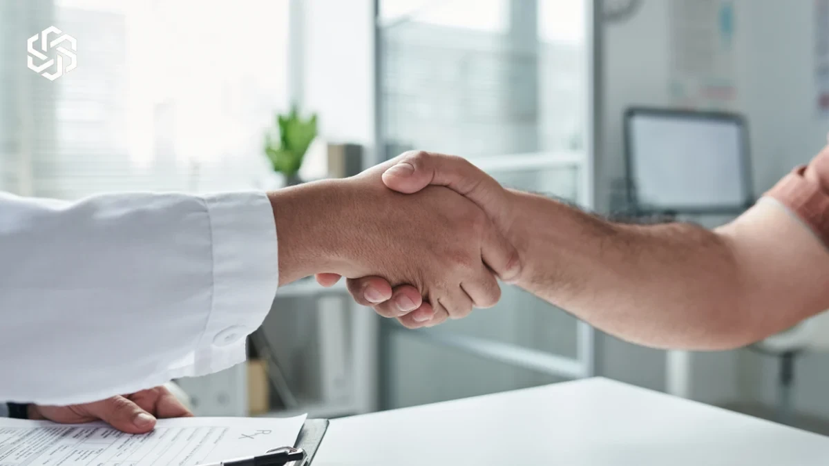 Patient shaking hands with a provider