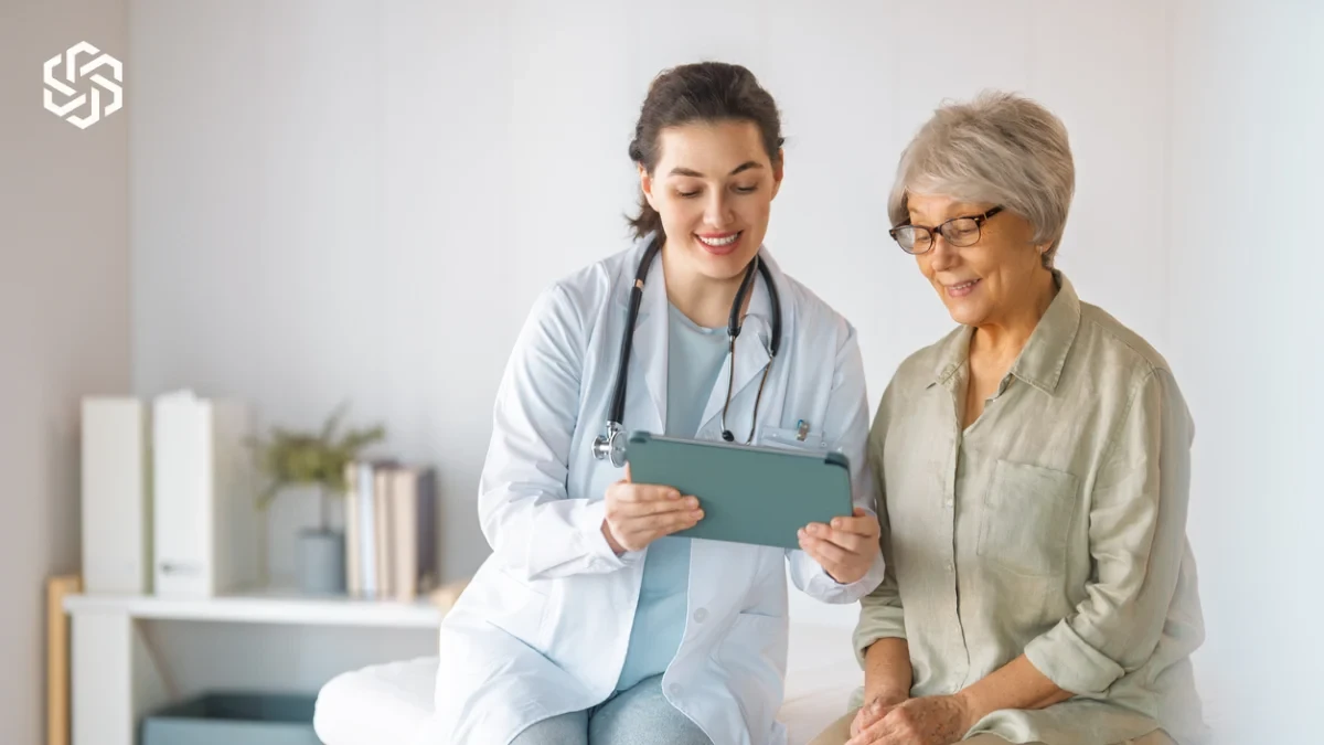 Provider reviewing a tablet with an older patient