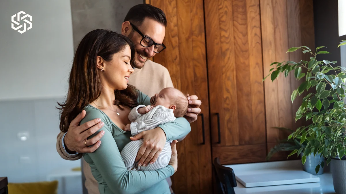 New parents holding their baby at home