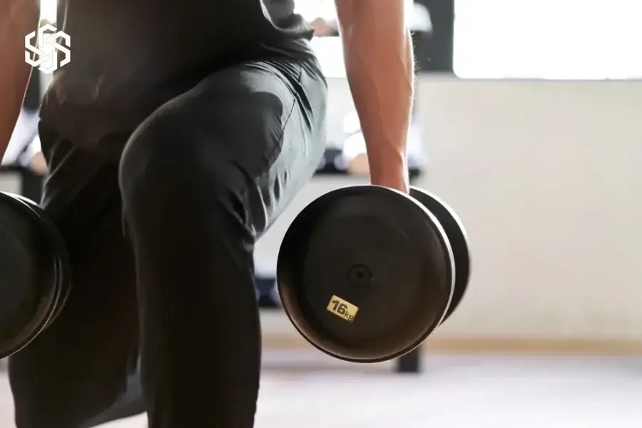 Man lifting dumbbells at the gym