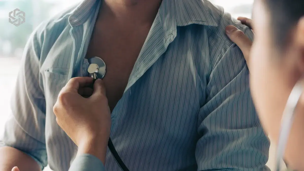 Provider listening to a patient’s chest with a stethoscope