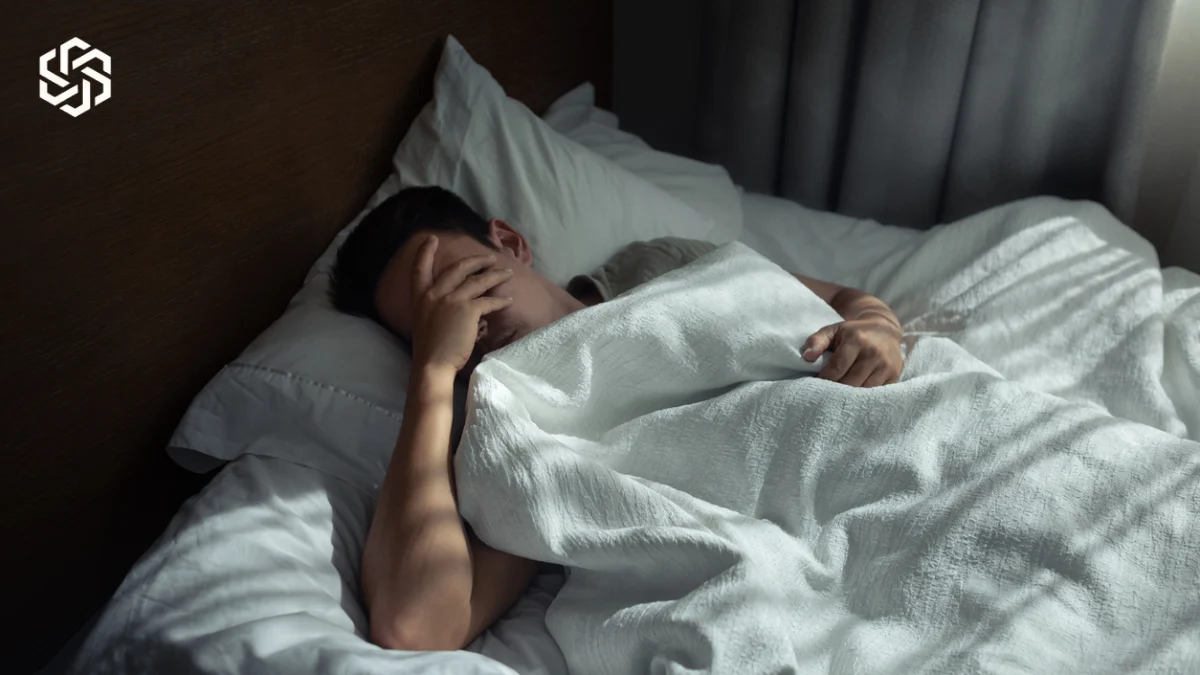Man lying awake in bed