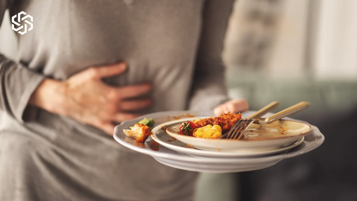 Woman with stomach discomfort after eating