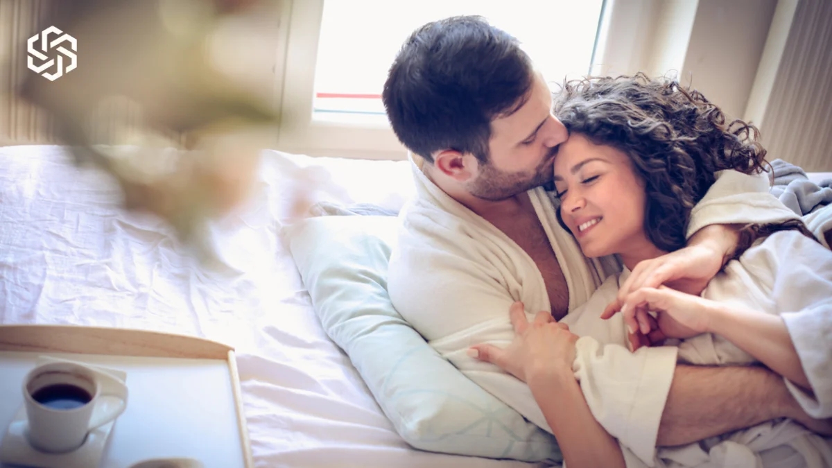 Couple relaxing together in bed in the morning